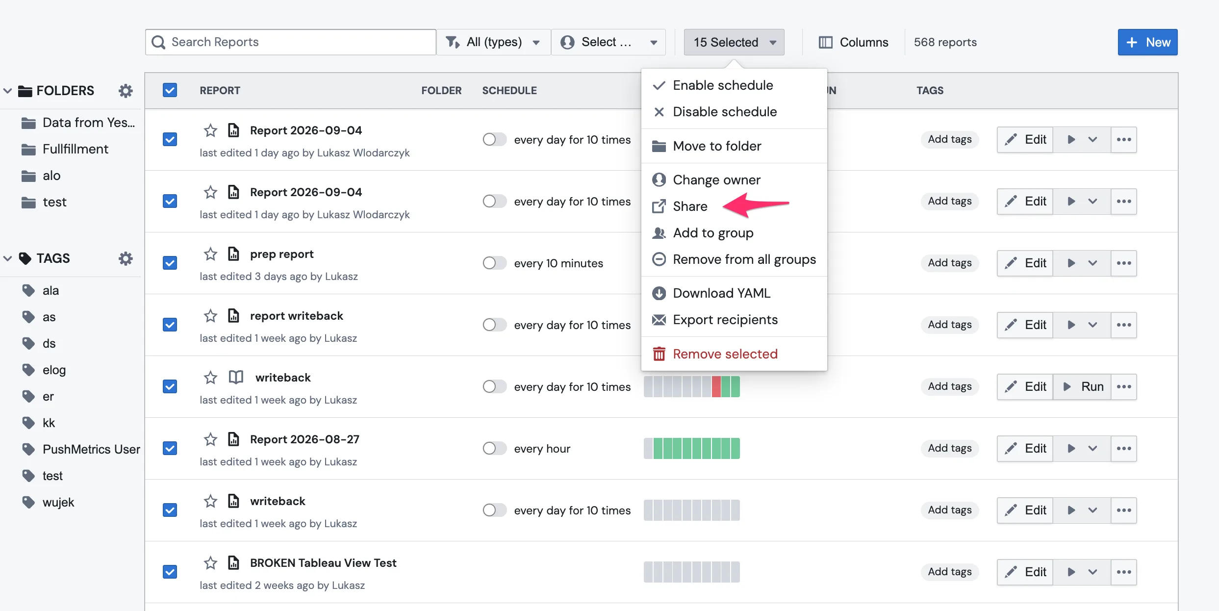 The report list with 15 reports selected and the bulk actions menu open, with the Share entry arrowed